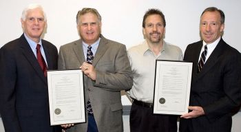 The CAN DO Community Foundation presented electricians with a resolution recognizing their efforts in restoring the Ferrwood Music Camp. From left: CAN DO President Kevin O’Donnell; Robert Judd, president of Arc Electric Construction Co.; John T. Nadolny, training director for International Brotherhood of Electrical Workers Local 163; and CAN DO Community Foundation President Gary F. Lamont.