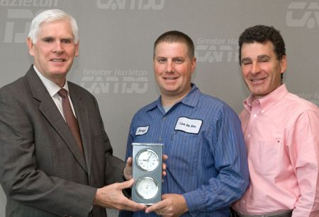 O'Donnell and Director of Operations Phil Wegener, right, present a clock to Demshock to mark his five-year anniversary.