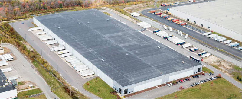 Aerial view of 400,000 square-foot facility at 68 Green Mountain Road. Shows the building and ample tractor trailer parking.
